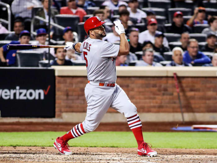 May 18, 2022; New York City, New York, USA; St. Louis Cardinals designated hitter Albert Pujols (5) hits a single in the fourth inning against the New York Mets at Citi Field.